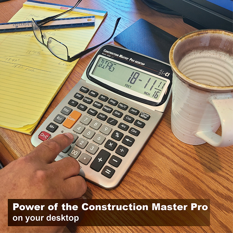 Hand using a Construction Master Pro Desktop calculator beside a notepad and mug