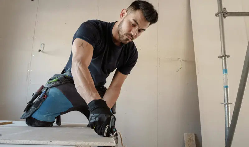 Man using a power tool on a construction site
